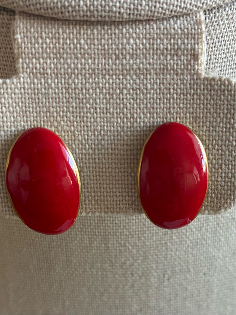 These are vintage oval red coral clip-on earrings with gold-tone hardware.